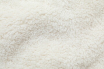 White cuddle teddy bear fabric as background, top view © Sunlight