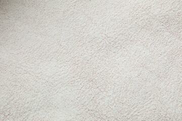 White cuddle teddy bear fabric as background, top view