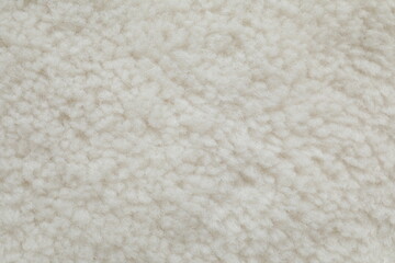 White cuddle teddy bear fabric as background, top view © Sunlight