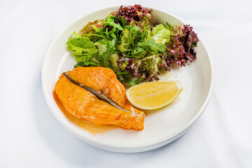 salmon steak with lettuce salad