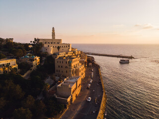 Beautiful Mosque by the Beach at Sunset - An aerial drone photo of the old town and port of Jaffa, Tel Aviv, Israel