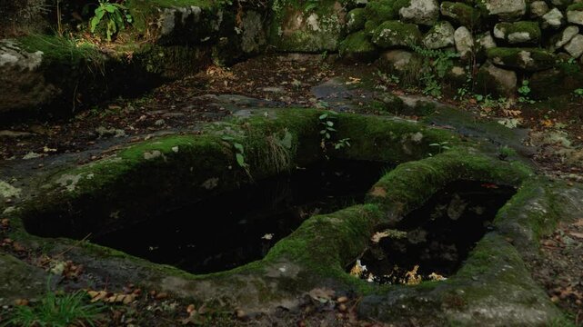 Old moss-covered stone fountain in Santa Mari&ntilde;a de Augas Santas, Allariz, Galicia, Spain