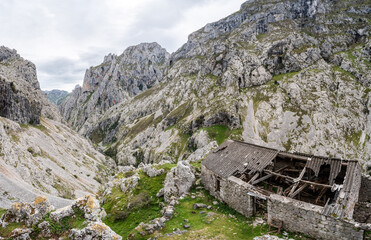 An abandoned ruined farmer house in the picturesque Cares gorge, Picos de Europa mountains in...