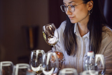 Woman Holding Wine Glass at Table