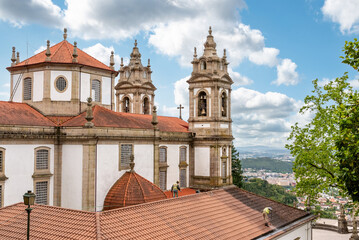 Fototapeta premium Two workers cleaning the roof of famous basilica Bom Jesus do Monte in Braga