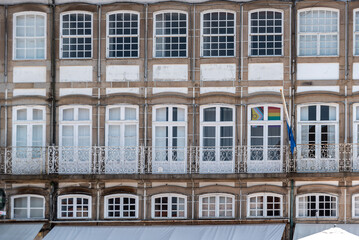 Traditional Portuguese facade with many windows at a house at Largo do Toural square in Guimaraes, Portugal