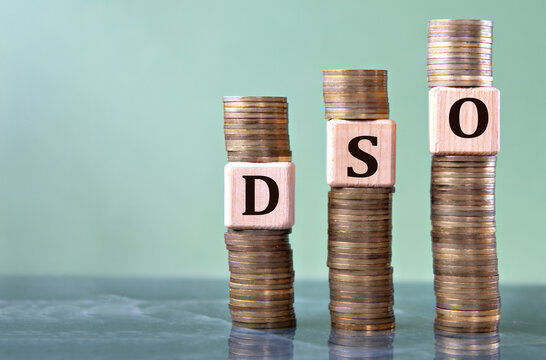 DSO - acronym on wooden cubes on stacks of coins