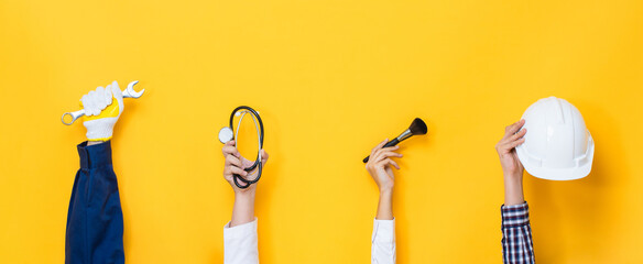 People hands in various diverse occupations holding tools and equipment in yellow color isolated...