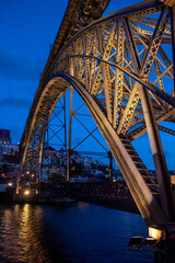 Architectural detail of iconic arched iron bridge Ponte Luis I in the Porto city center at night