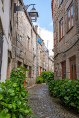 Picturesque medieval narrow alleyway in the center of Tracoso, showing the alley Rua de Alegria
