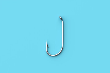 Shiny metallic fish hook lying on a blue background