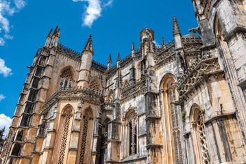 Fototapeta premium Picturesque facade of medieval Santa Maria da Vitoria monastery church in Batalha, a manueline gothic masterpiece, view on the southern facade
