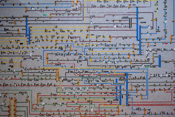 Intricate network diagram displaying multiple interconnected lines and elements on a grid of an...