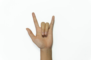 Female hand showing rock n roll sign or giving the devil horns gesture