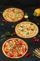 Three different Italian pizzas on a black background, vertically.