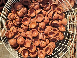 Diya's selling in the market for diwali occasion. People selling hand made diye (handmade candle or oil candle). Stock of dipawali diya's. Collection of diya or oil lamp. 