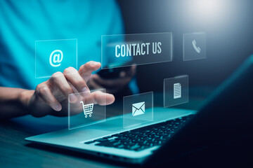 Communication and Contact us or Customer support hotline people connect. Hand using a laptop and touching on virtual screen contact icons, email and address, live chat with internet wifi.
