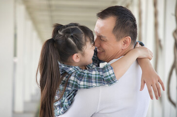 Happy smiling Asian father and daughter staying together, concept image for healthy family, good father, middle aged dad parenting, child development