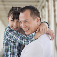 Happy smiling Asian father and daughter staying together, concept image for healthy family, good father, middle aged dad parenting, child development