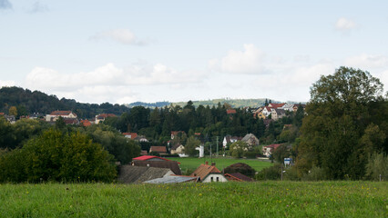 An autumn view of Stříbrná Skalice, a key location from Kingdom Come: Deliverance, with vibrant fall colors highlighting the village’s historic charm.