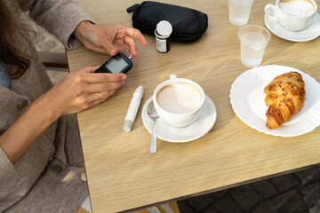 Diabetic woman measuring sugar level. Preparing a diabetic to eat