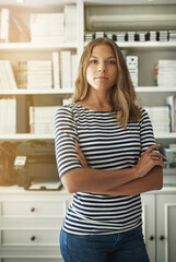 Woman, portrait and publisher in home office, arms crossed and bookshelf for editing fiction. Female person, story writer and proud of novel collection, confident and independent startup company