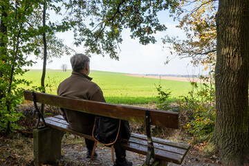 Lonely Senior Old Man Sitting on Bench in Park.