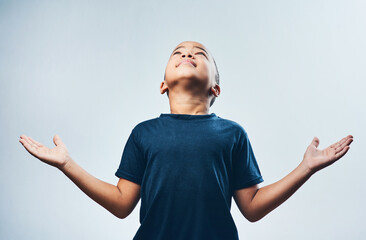 Praying, religion and child with faith, studio and boy with trust in holy spirit, belief and hope....