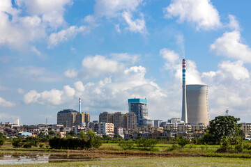 A thermal power station that emits steam under the scorching sun