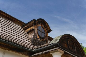 Round windows in an old house with a wooden roof