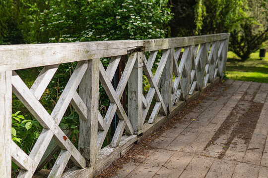 Old wooden bridge with white painted railings