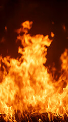 Close-up of fiery flames burning brightly in the dark.