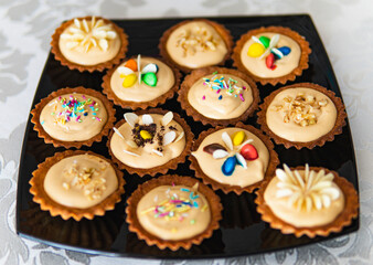 Detail of small cupcakes on black plate