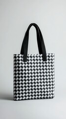 This tote bag has a chic black and white houndstooth pattern, perfect for any outfit