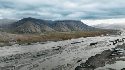 Breathtaking Svalbard landscape at sunset, featuring a winding river and natures beauty