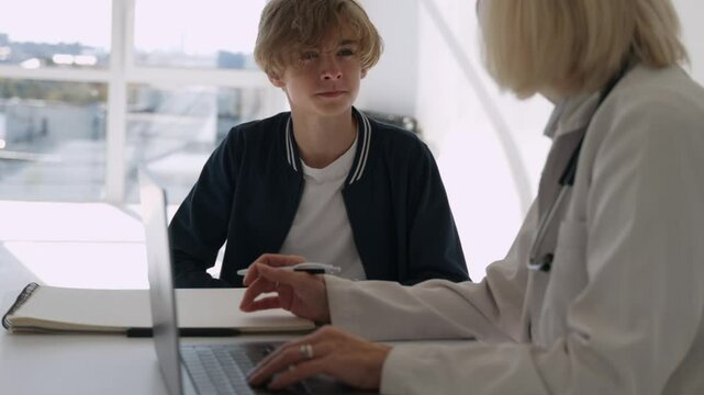 Woman psychologist doctor, counselor talking with boy child. Kid's counseling session. Child's emotional comfort. School psychologist discussion. Therapist's empathy talk