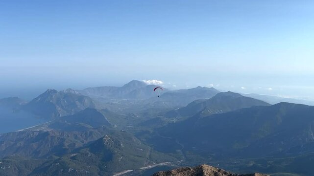 Paraglider flying between the mountains.