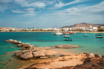 A stunning view of Naxos Island, Greece, featuring crystal-clear turquoise waters, rugged coastlines, and charming white-washed buildings. A picturesque paradise for travelers and sun-seekers.