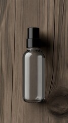 Naklejka premium A classic spray bottle design rests on a textured wooden surface, highlighting its sleek form