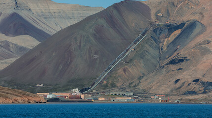 Exploring the abandoned mining town of Pyramiden on the coast of Svalbard in bright daylight