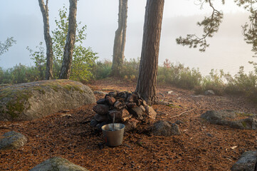 Camping site near water with small fireplace