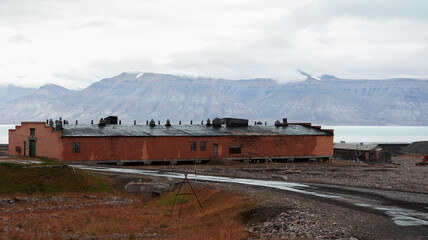 Exploring the abandoned buildings of Pyramiden in Svalbard under cloudy skies