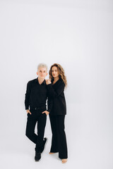 Man and woman in black on a white background