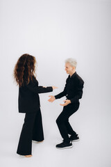 Passionate performance. Stylish couple, man and woman dancing bachata against dark green background. Concept of dance, performance, art, emotions, entertainment