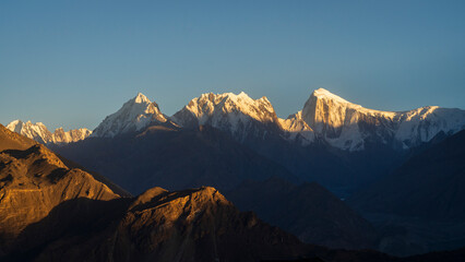 Obraz premium Scenic mountain landscape panorama of snow-capped Spantik aka Golden Peak and other Karakoram peaks before sunset, Hunza, Gilgit-Baltistan, Pakistan