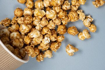 Sweet caramelized popcorn spilled out of the glass.