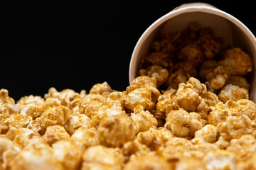 Sweet caramelized popcorn spilled out of the glass.