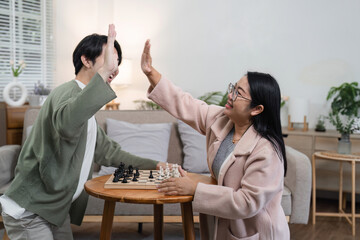 Joyful Mother and Son Bonding Over Board Games in a Cozy Living Room Setting