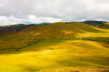 Landscape of the highlands with hills and meanders on the meadow