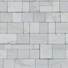 Obraz premium A close-up of white marble tiles arranged in an elegant, contemporary pattern, showcasing subtle veining and a clean, polished surface.